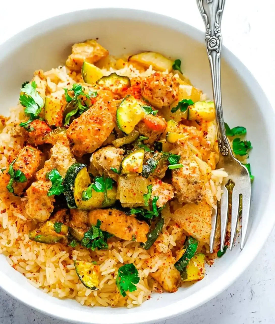 Plate of easy baked chicken and zucchini, a healthy and delicious dinner option.