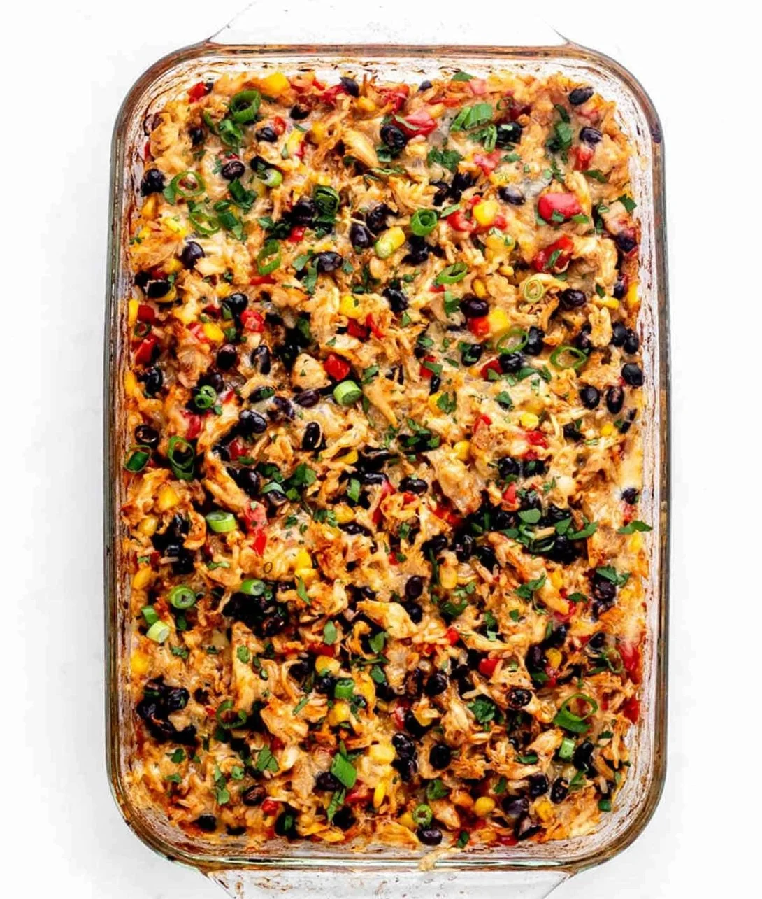 Delicious easy chicken burrito casserole topped with cheese and fresh ingredients.