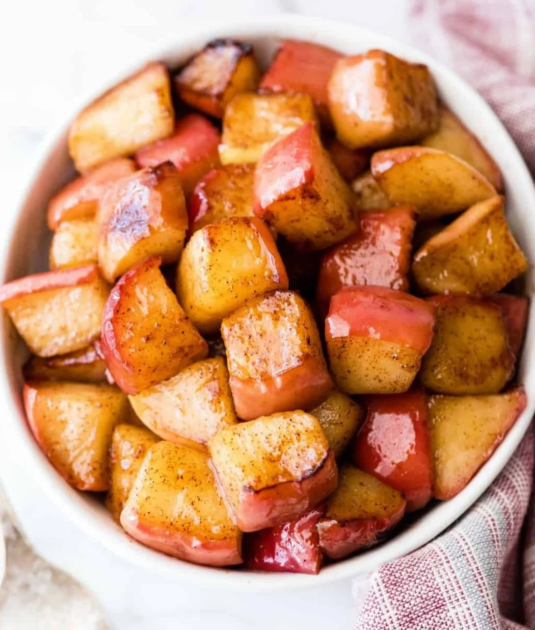 Bowl of easy cinnamon apples with a sprinkle of cinnamon and sugar