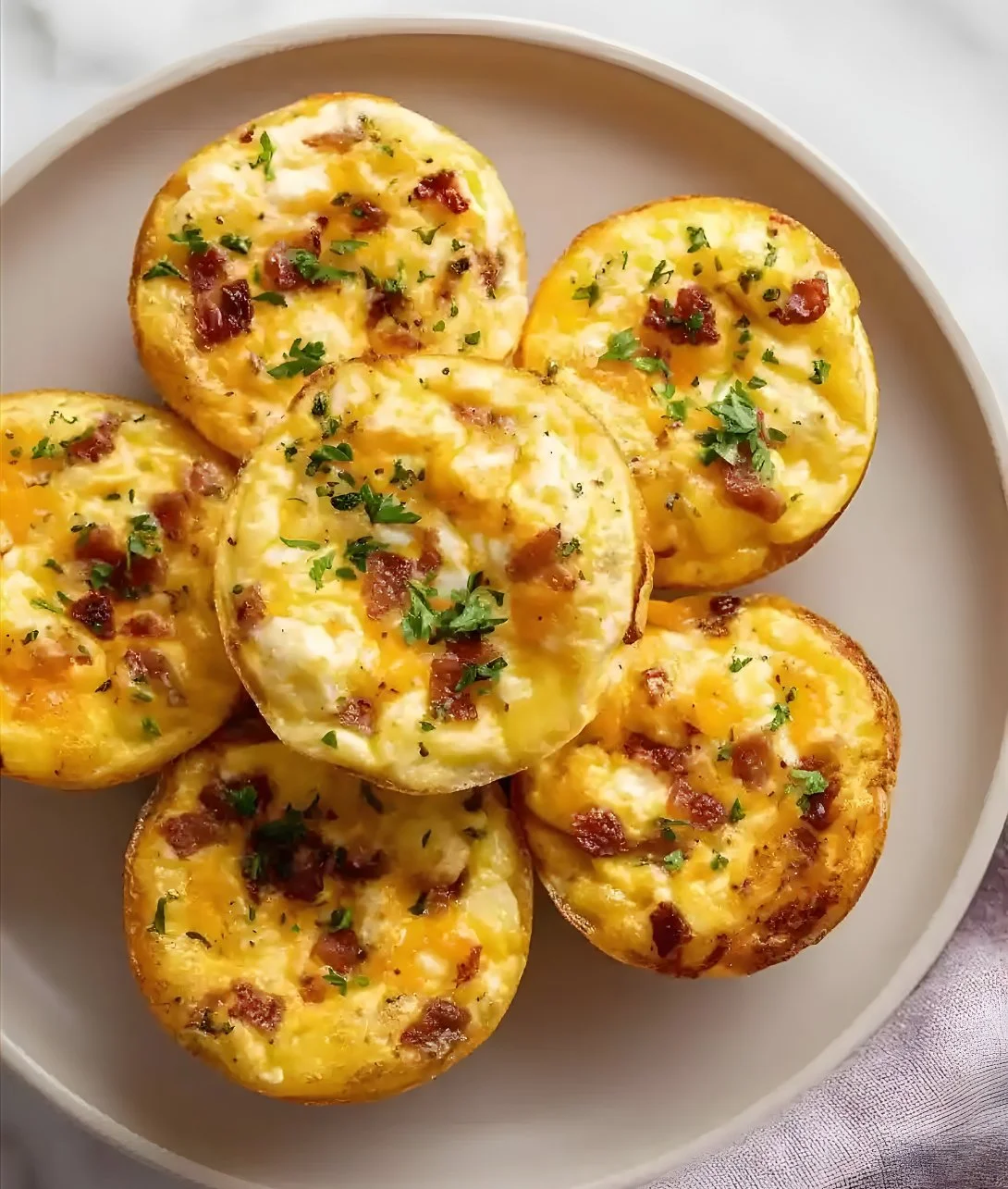 Easy cottage cheese egg bites in a serving dish with fresh herbs