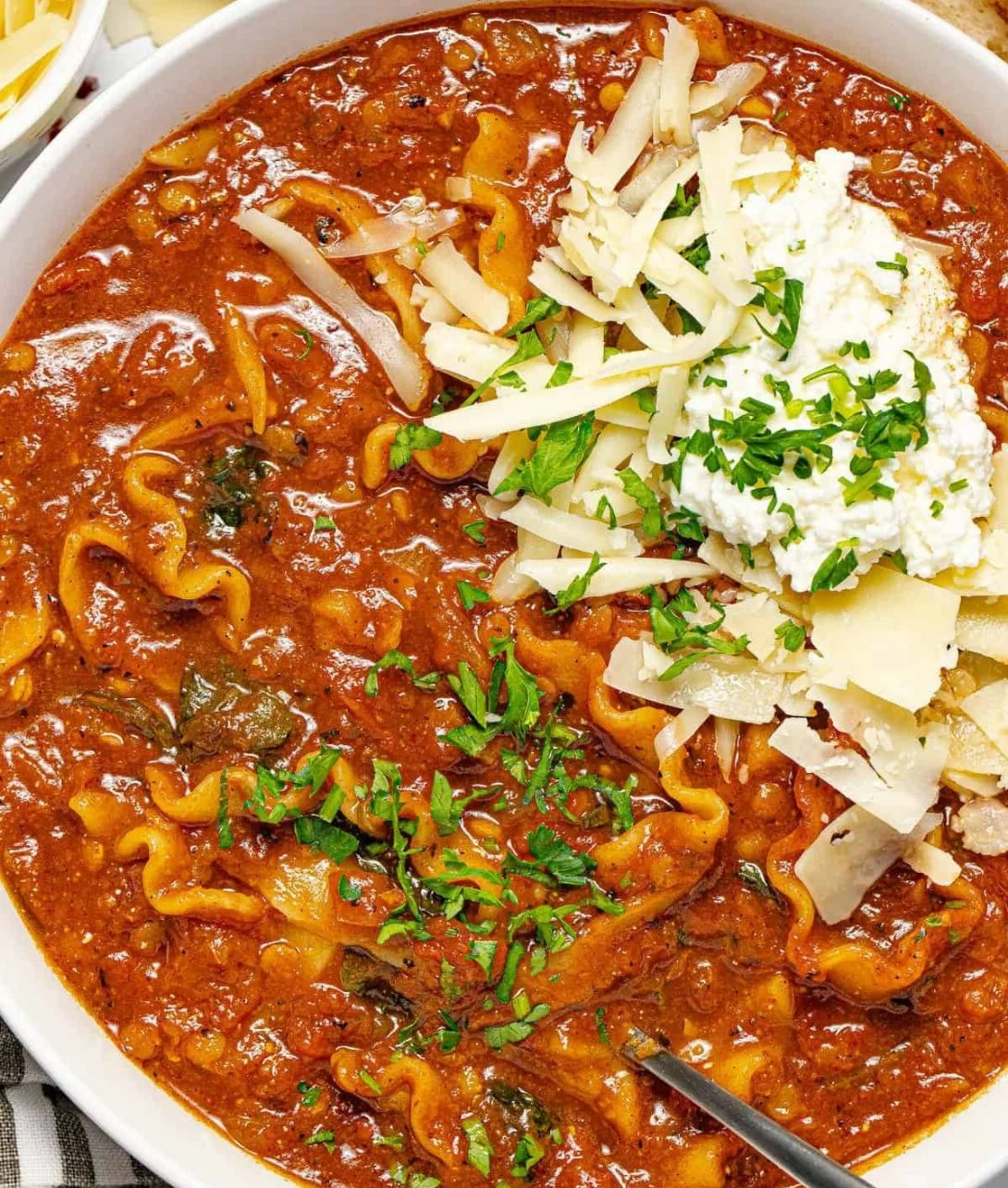 Easy vegetarian one pot lasagna soup in a bowl with fresh herbs