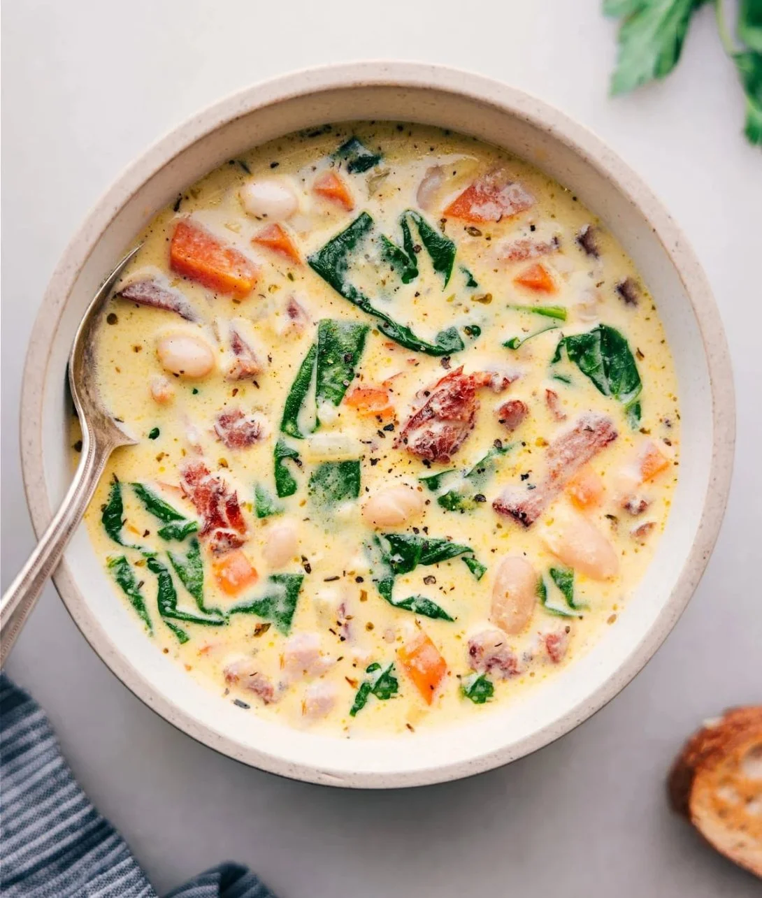 Delicious bowl of ham and bean soup garnished with herbs