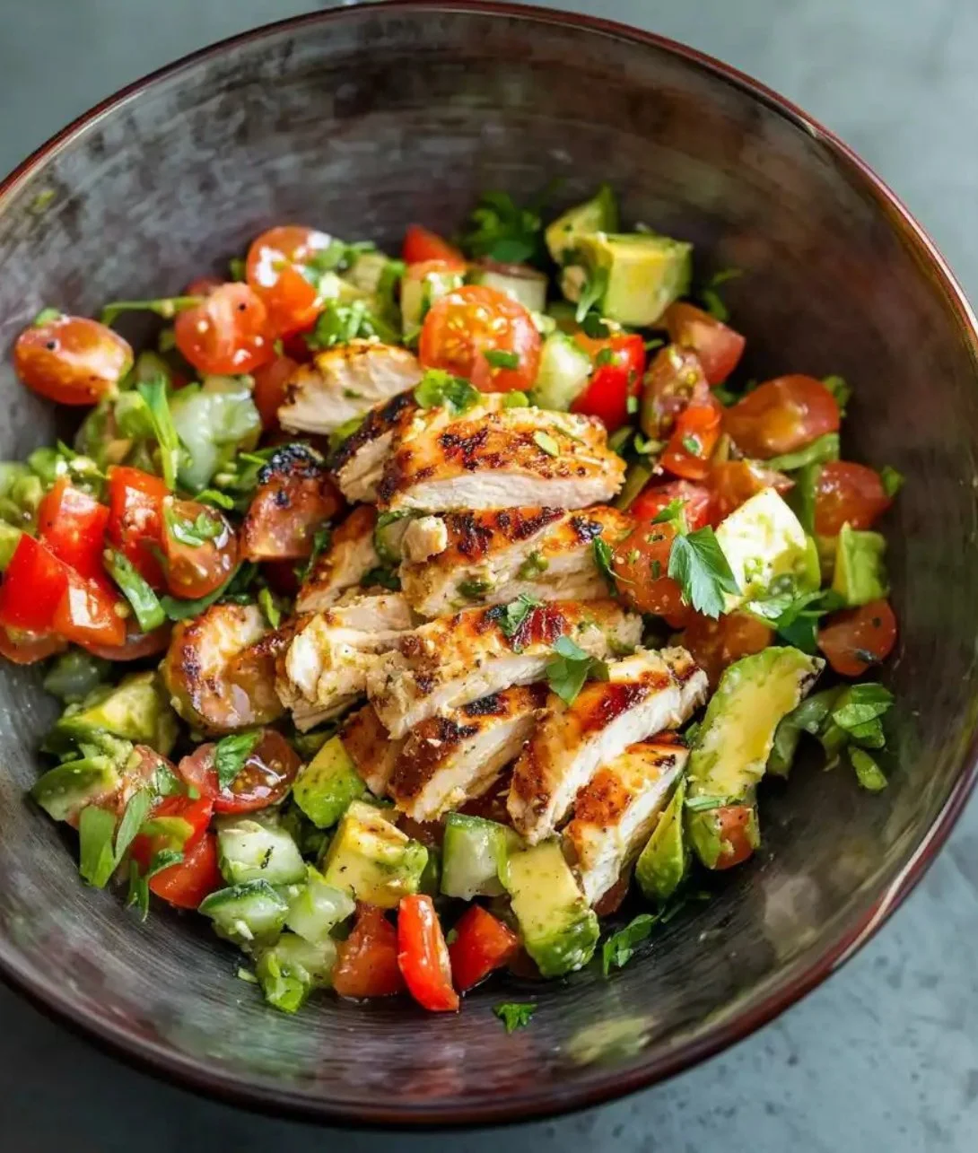 Healthy avocado chicken salad with fresh ingredients served in a bowl