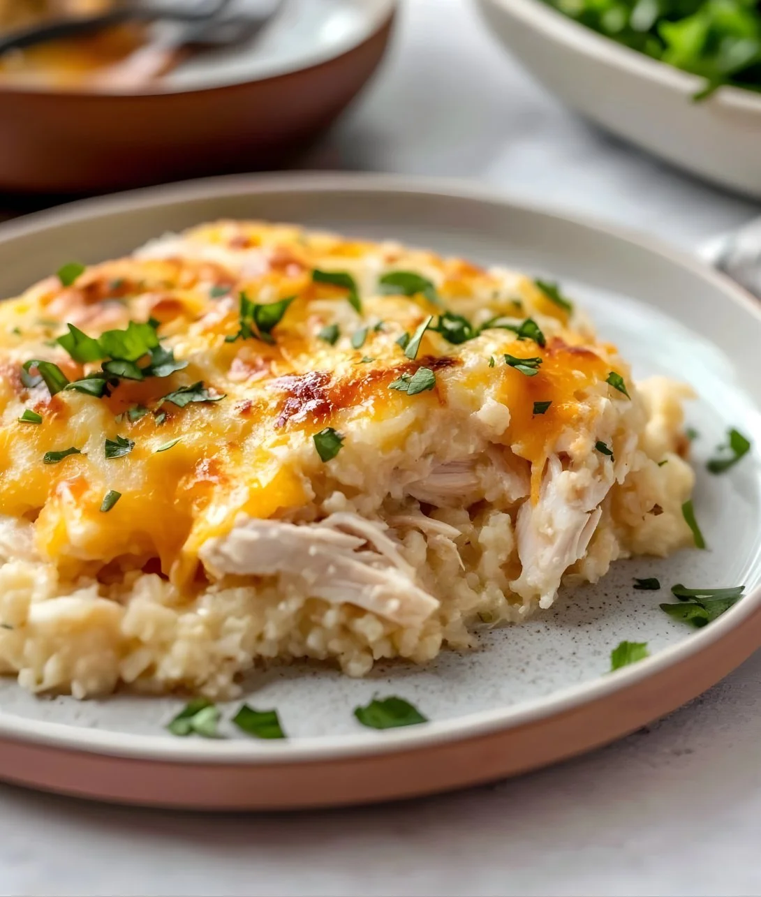 Healthy chicken cauliflower rice casserole recipe with veggies and seasonings.