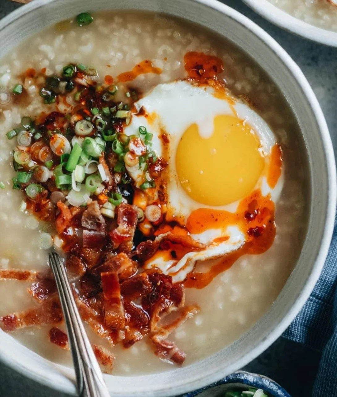 Bowl of instant pot breakfast congee topped with green onions and sesame seeds