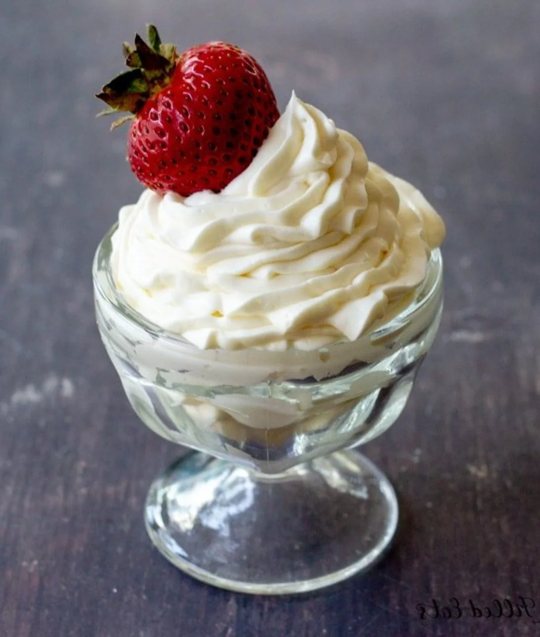 Delicious Keto Cheesecake Fluff dessert in a glass with berries on top