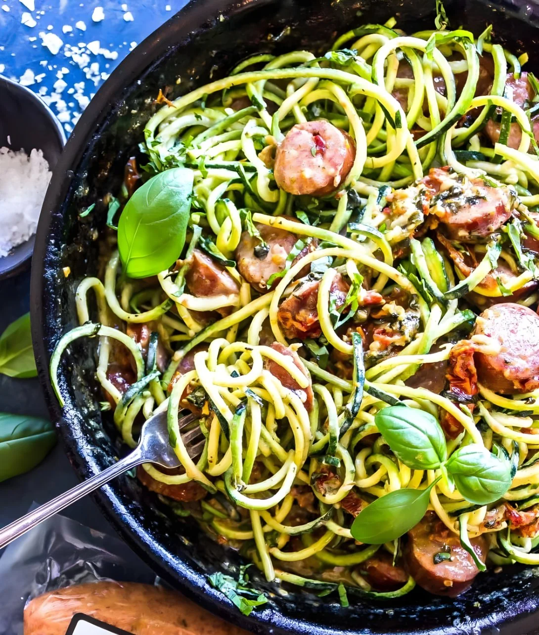 Keto Creamy Tuscan Zucchini Noodles topped with sausage in a creamy sauce