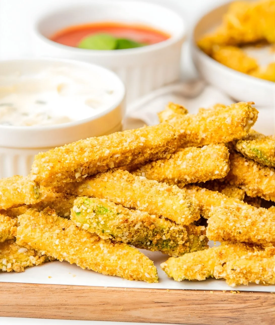 Crispy Keto Zucchini Fries served on a plate with dipping sauce