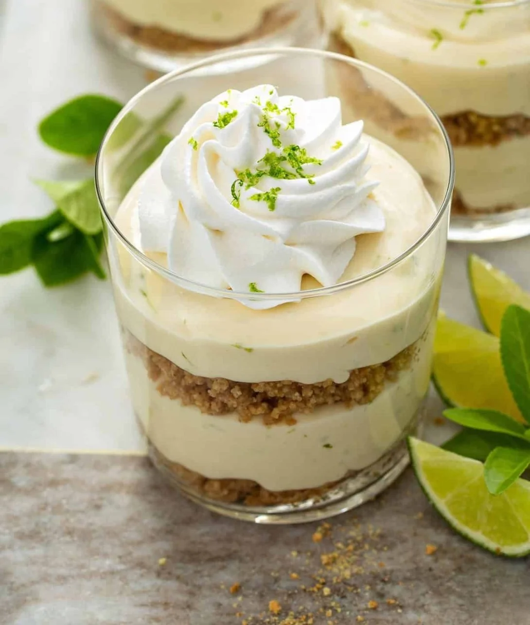 Delicious Key Lime Cheesecake Parfaits in glass cups with lime garnish