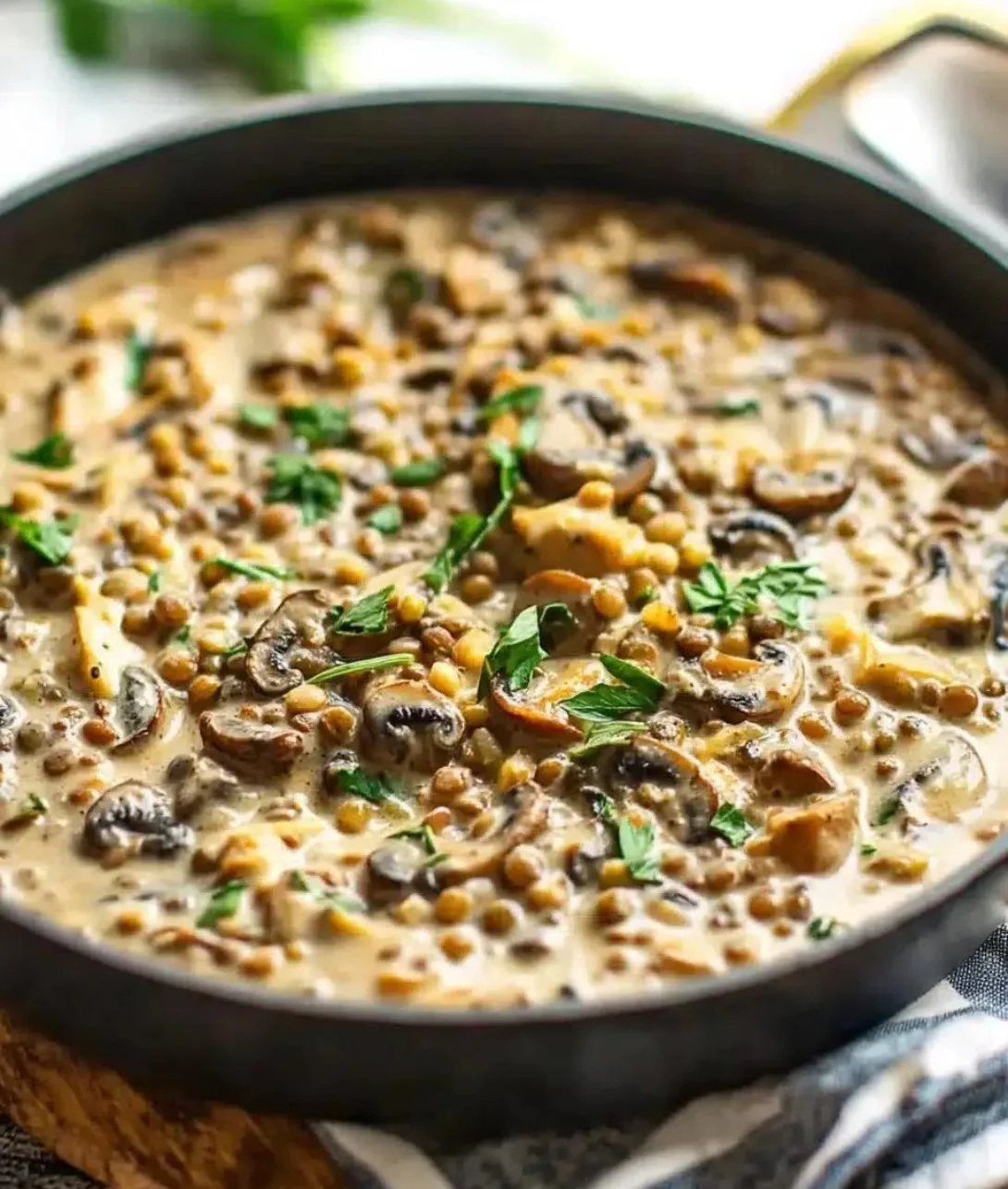 Delicious Lentil Mushroom Stroganoff served in a bowl with herbs garnish
