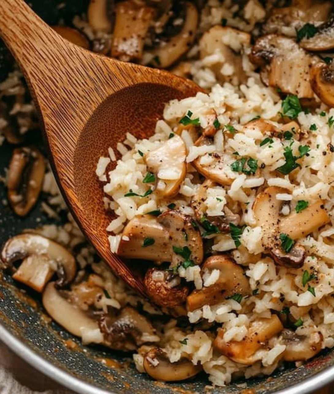 Delicious one-pot mushroom rice dish garnished with fresh herbs.