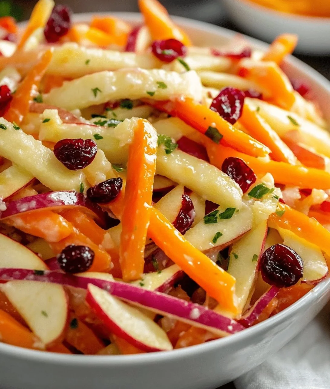 Delicious apple cranberry salad with carrots in a bowl