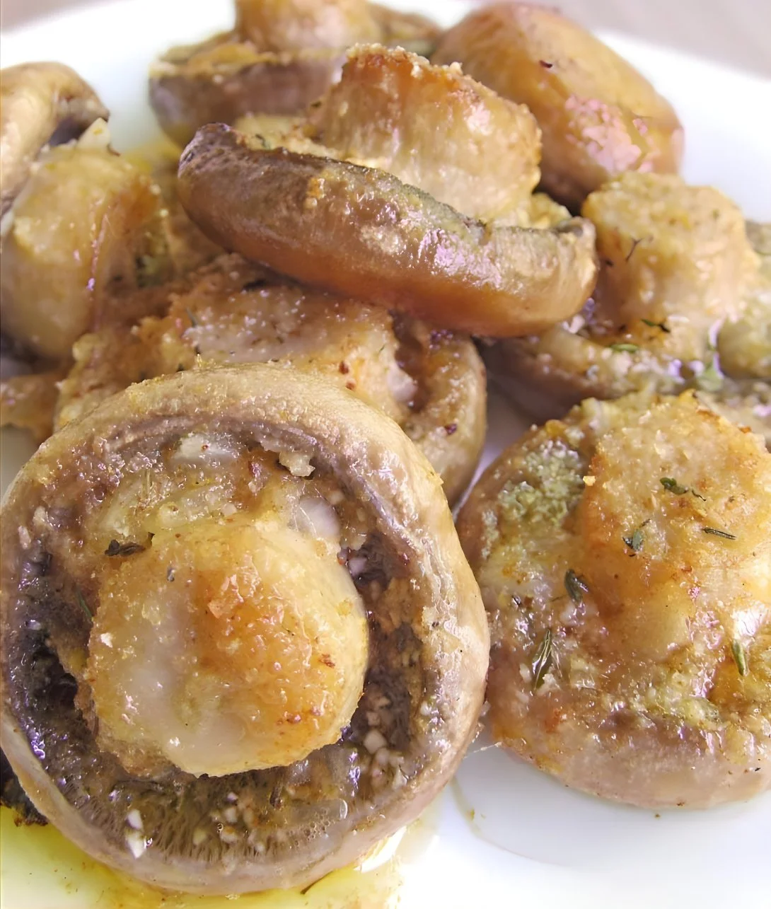 Plate of roasted mushrooms with garlic and thyme seasoning