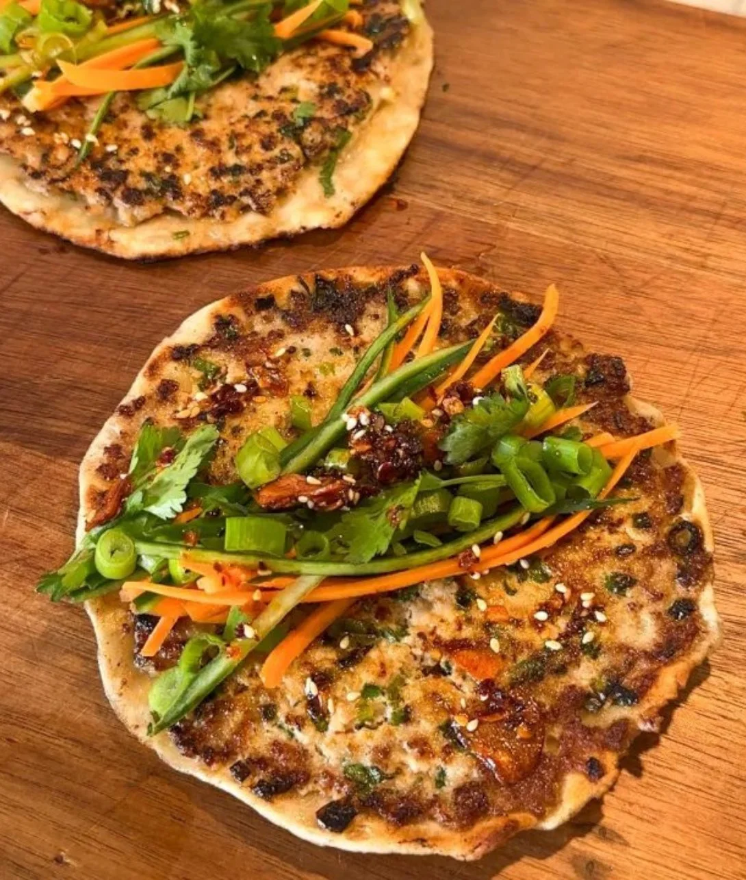 Smash dumpling tacos with vibrant fillings and sauces on a platter