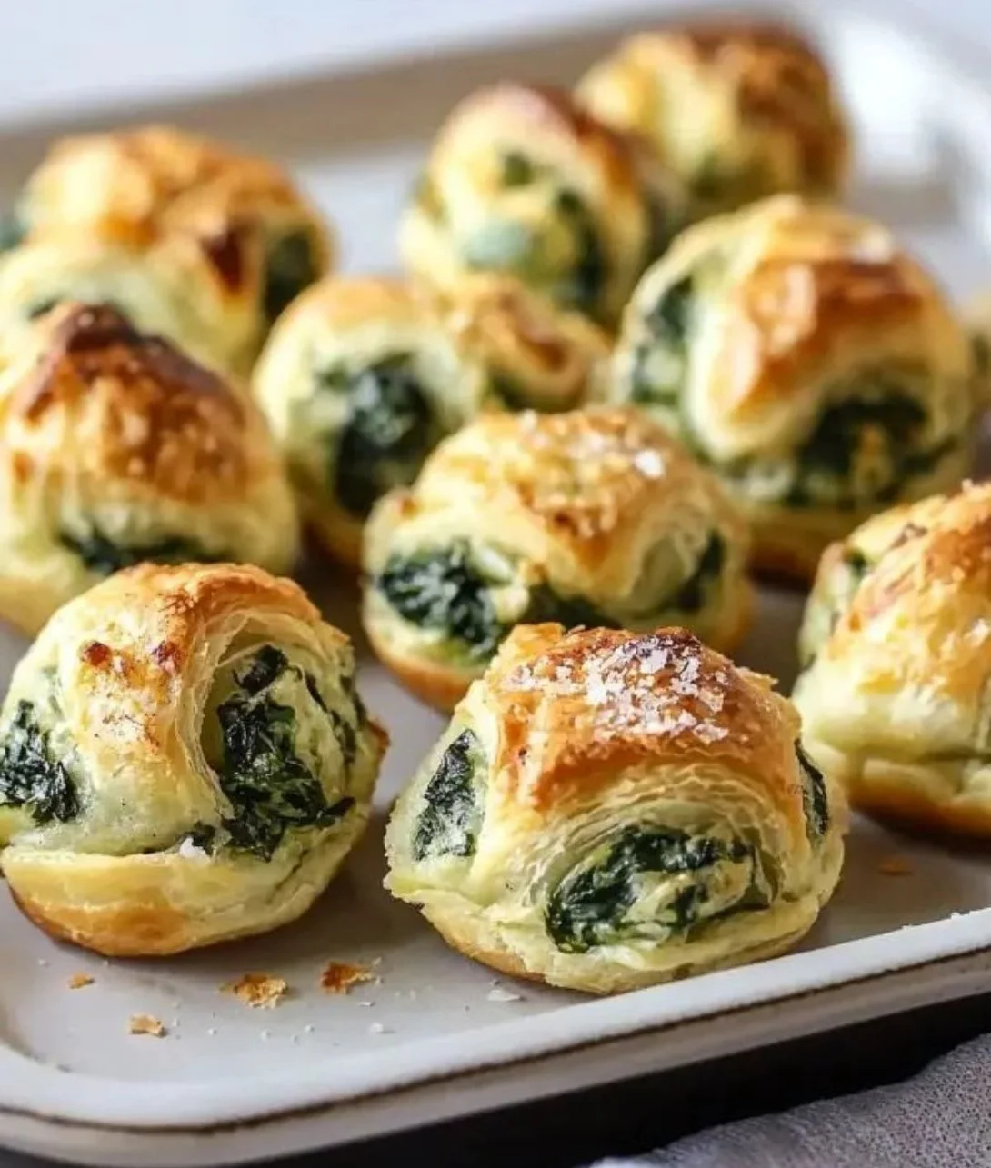 Deliciously golden spinach puffs on a plate, ready to enjoy