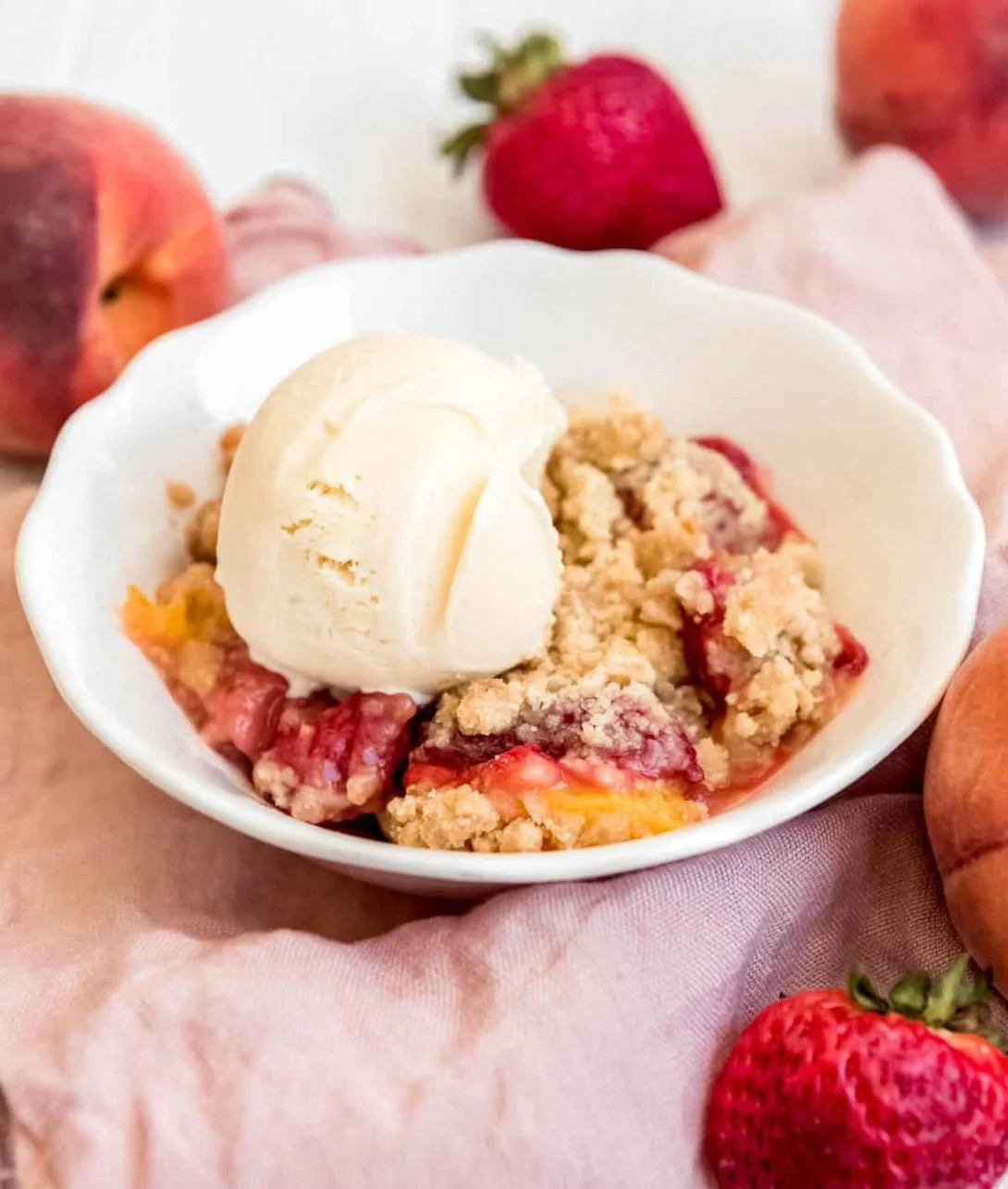 Delicious Strawberry Peach Crumble dessert topped with golden crumble