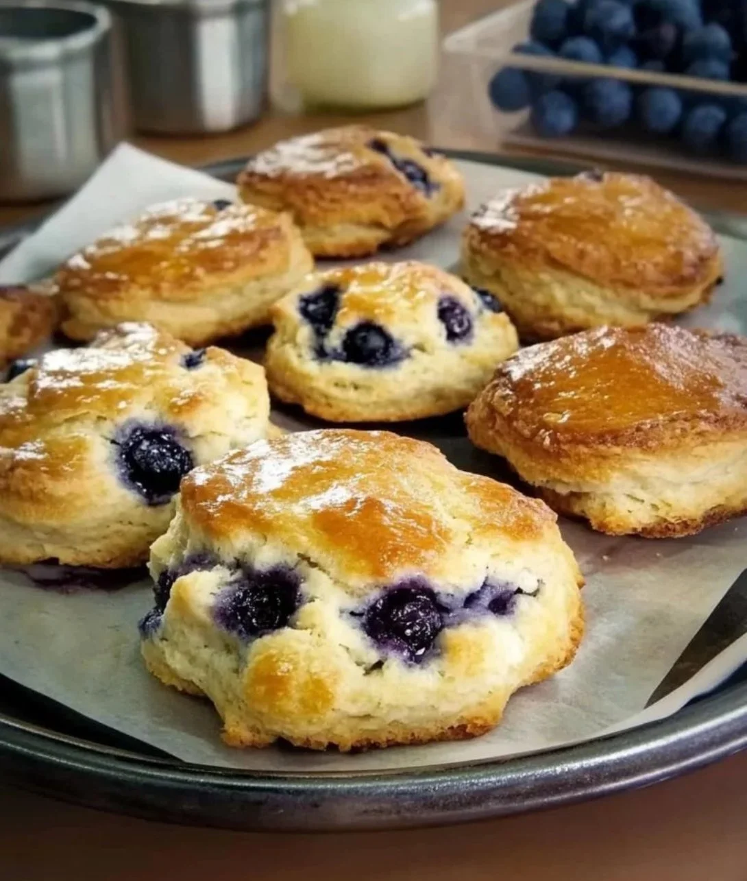 Freshly baked sweet blueberry biscuits on a rustic table.