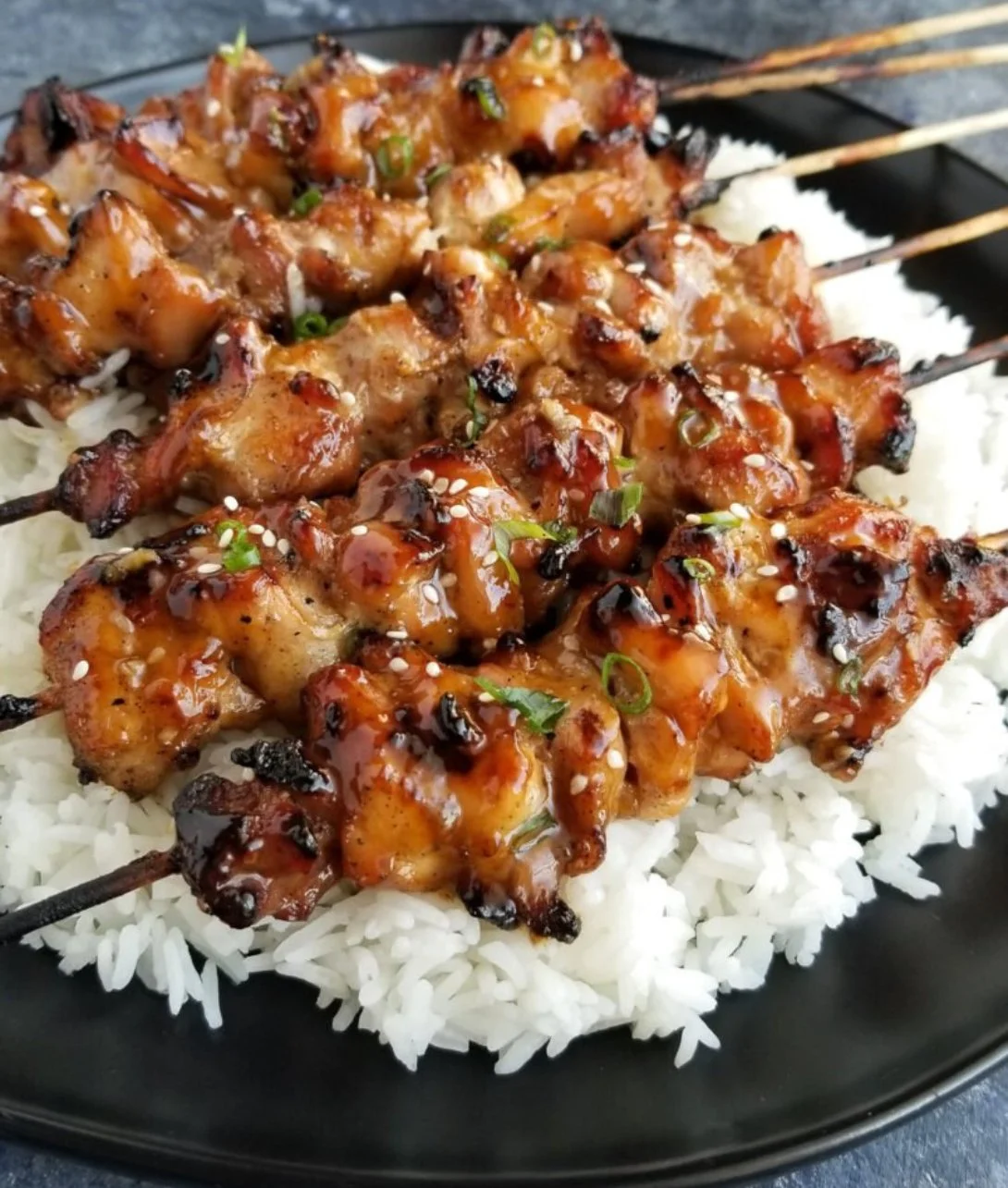 Delicious Teriyaki Chicken Skewers served on a plate with vegetables