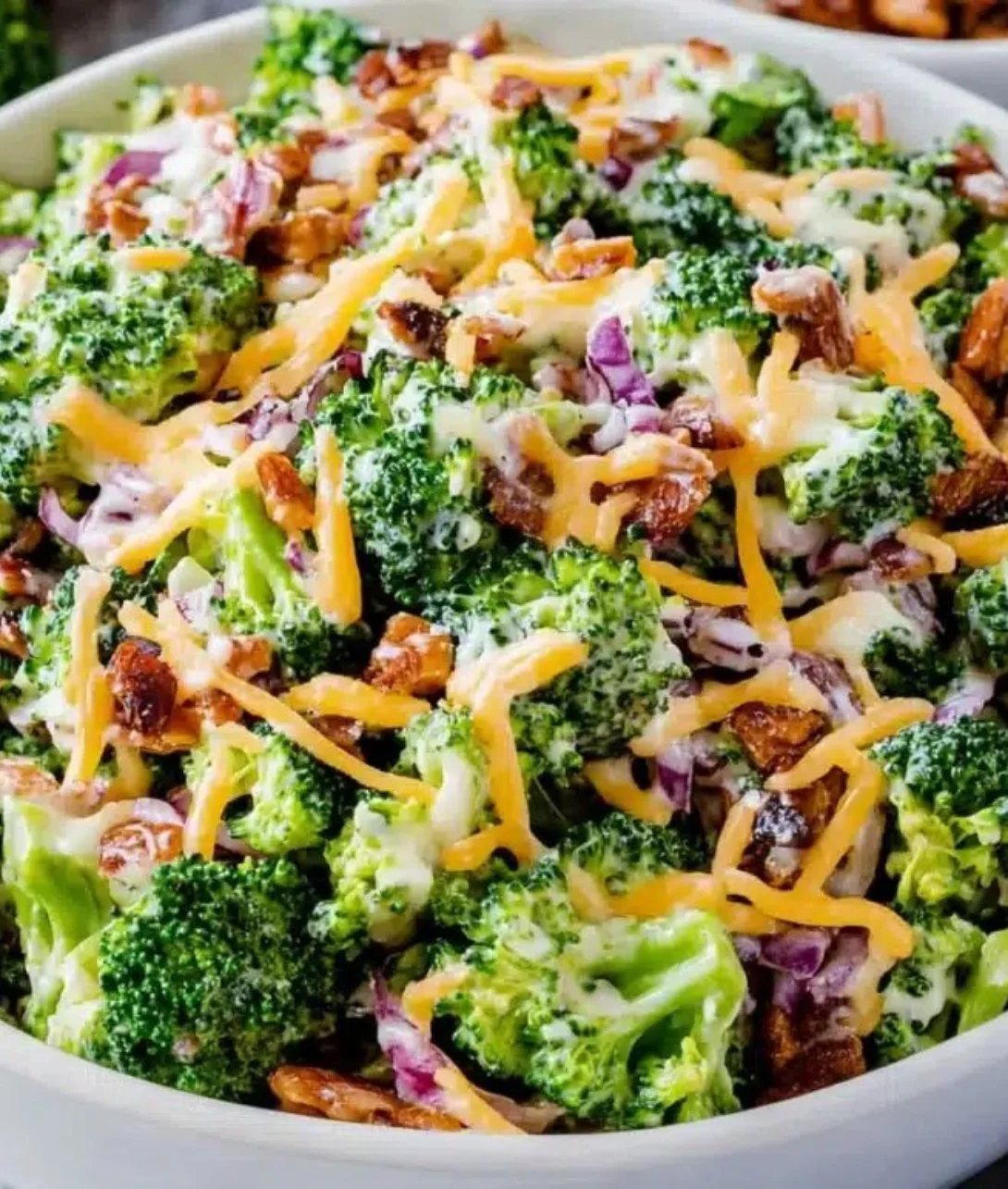 Delicious and colorful broccoli salad with toppings in a bowl