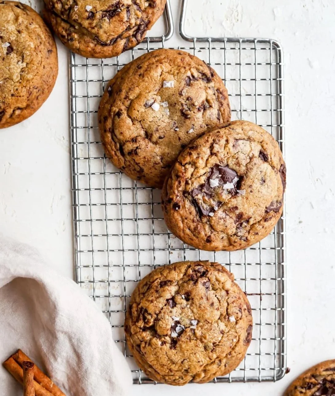 Vietnamese cinnamon chocolate chip cookies on a plate with a sprinkle of cinnamon