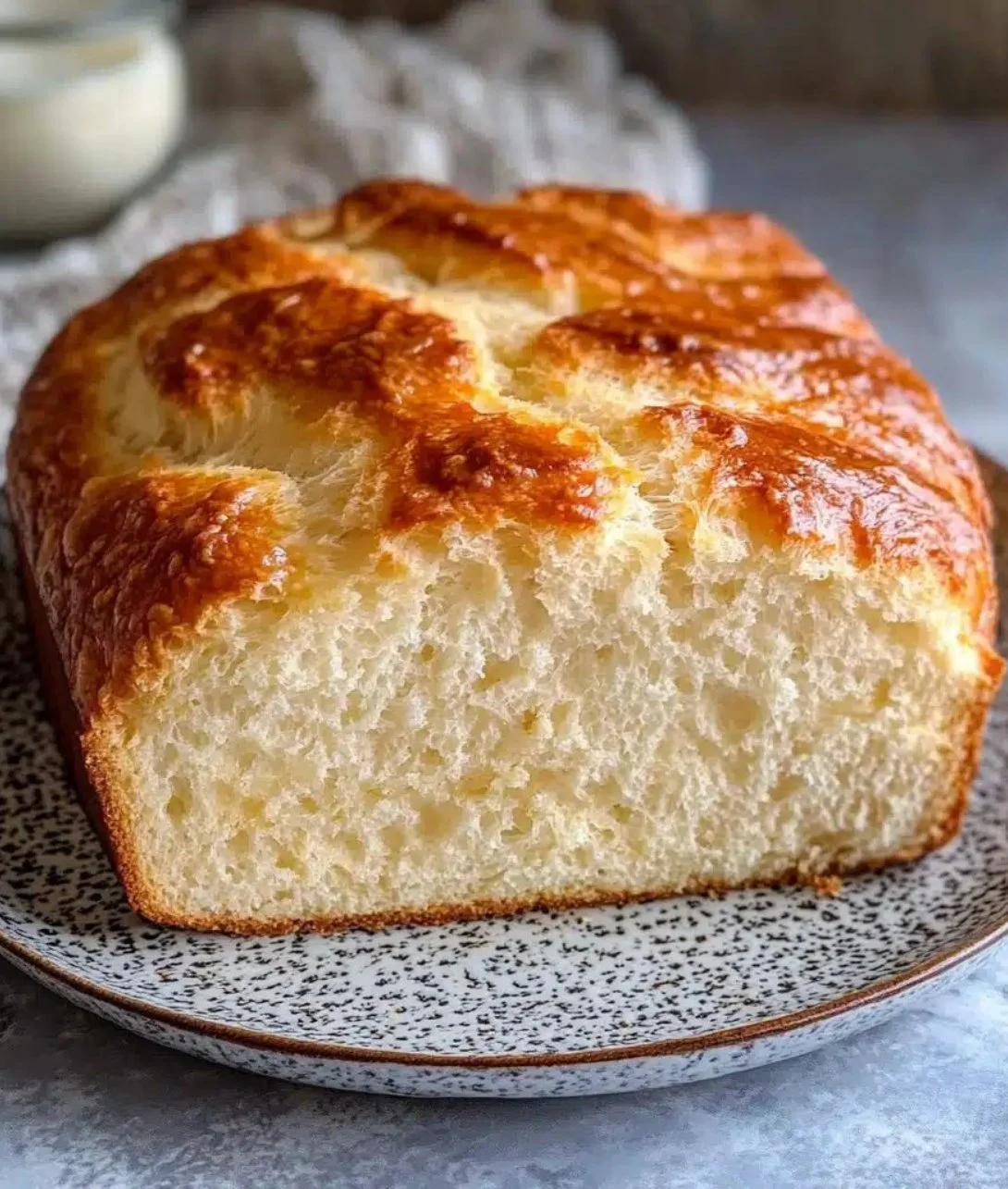 Slice of zero carb yogurt bread on a wooden cutting board