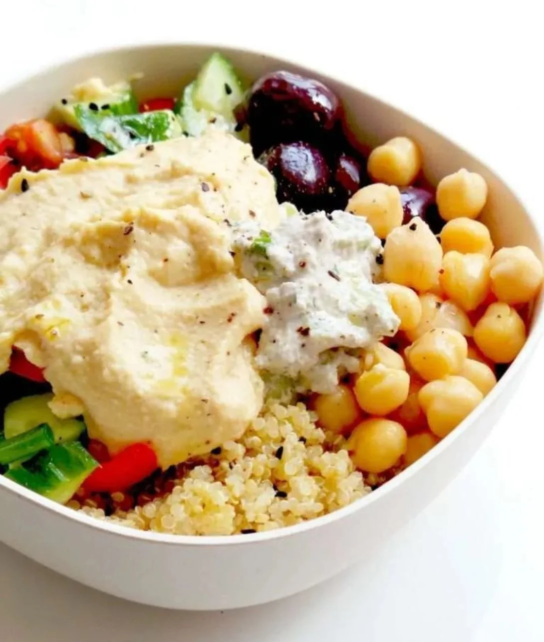 A colorful Mediterranean Bowl featuring fresh vegetables, grains, and protein.