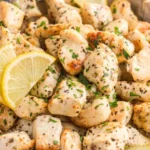 Air Fryer Lemon Chicken Bites served on a plate with fresh herbs