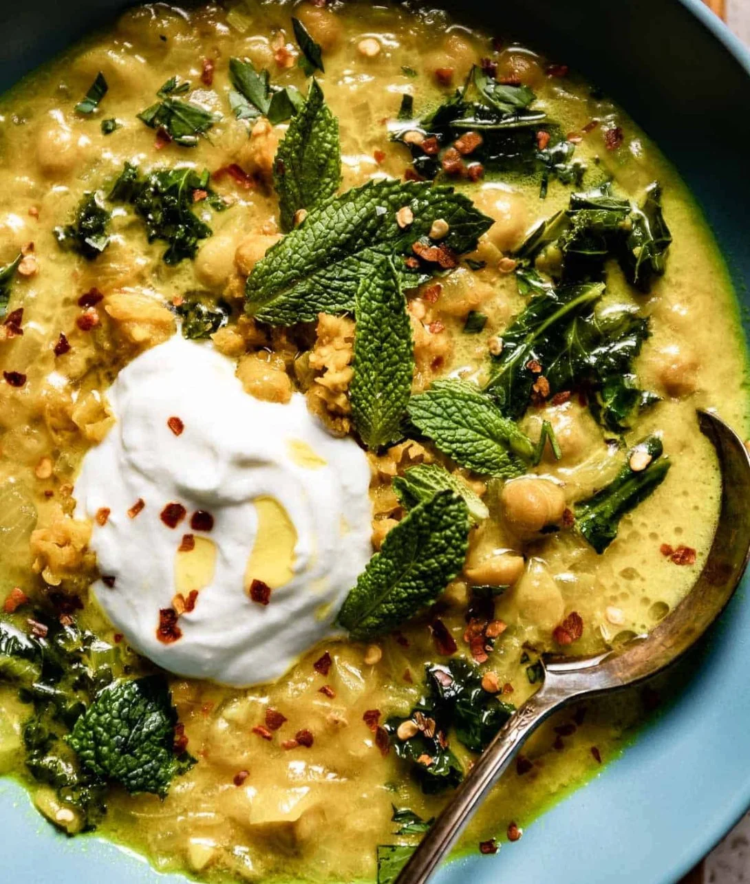 A bowl of Alison Roman's The Stew, showcasing colorful vegetables and rich broth.