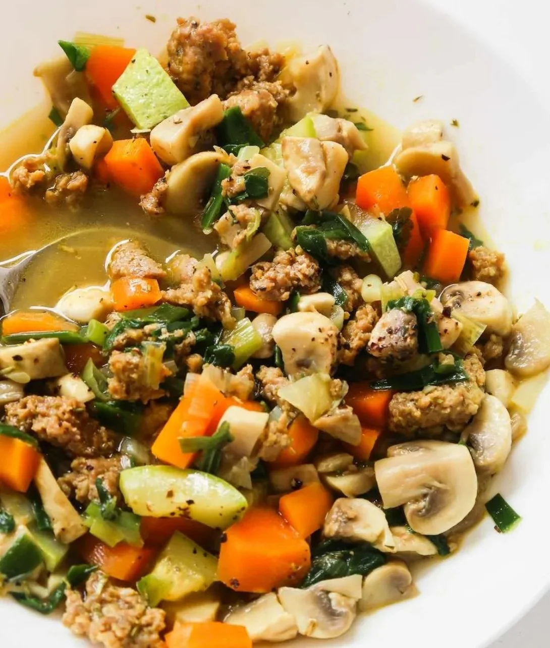 Bowl of anti-inflammatory ground turkey soup with colorful vegetables