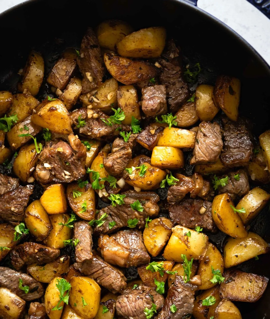 Asian steak bites with potatoes served on a plate