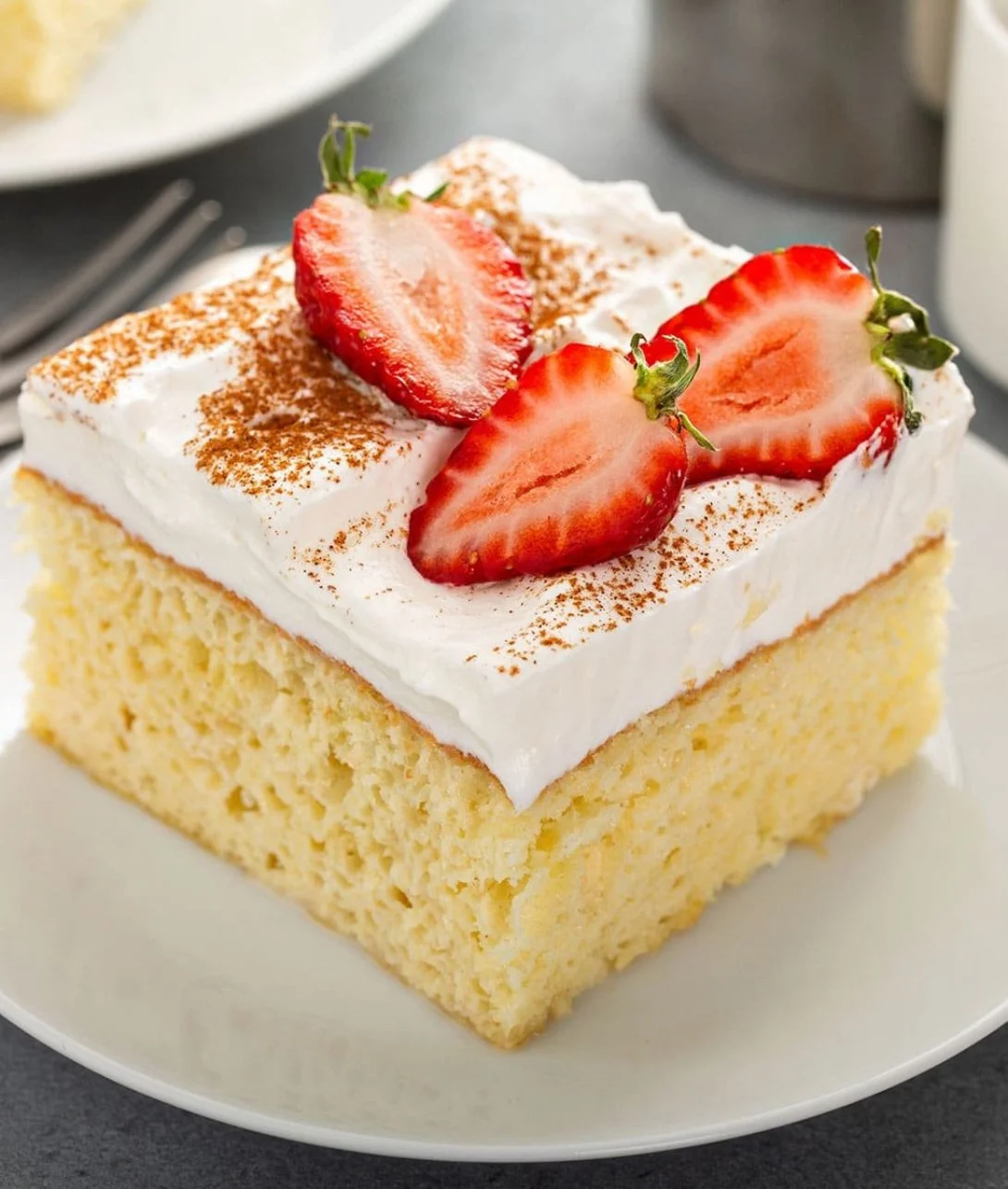 Authentic three milks cake topped with cream and fruit, a must-try dessert