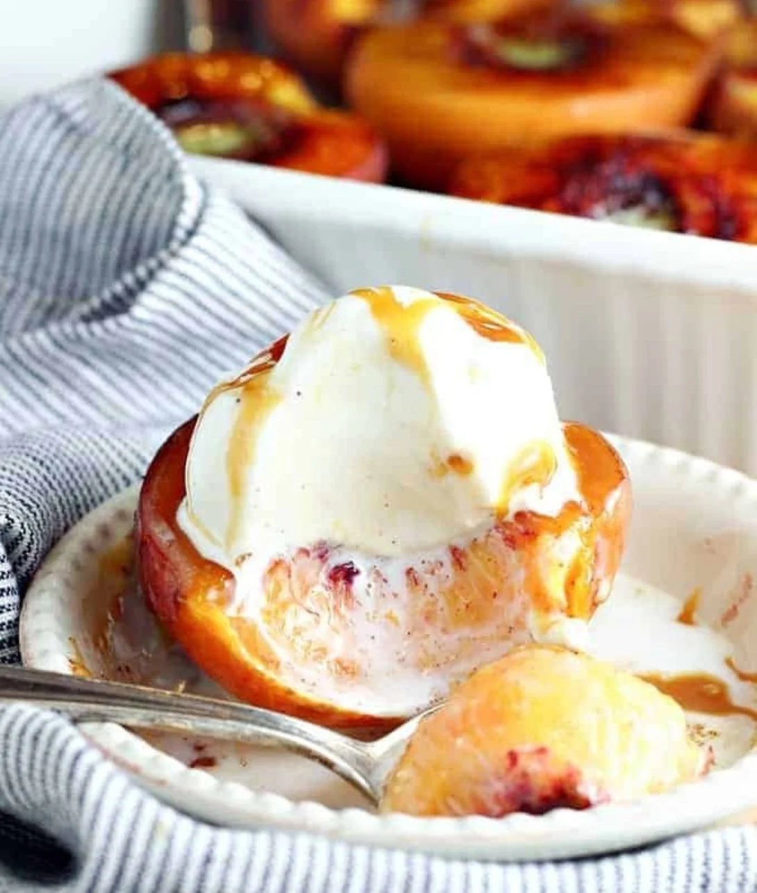 Cinnamon sugar baked peaches served warm with a sprinkle of cinnamon on top