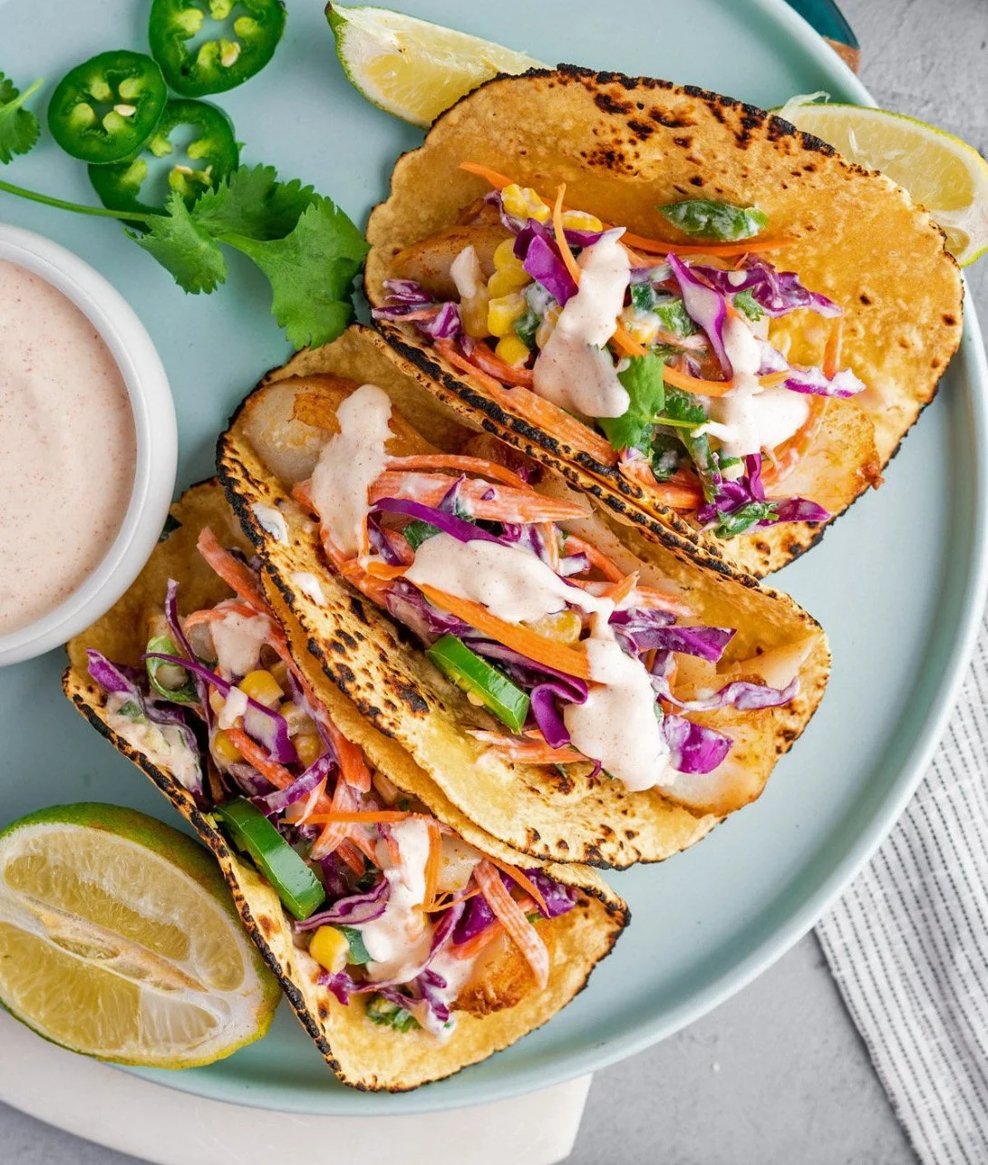 Deliciously prepared cod fish tacos topped with fresh ingredients