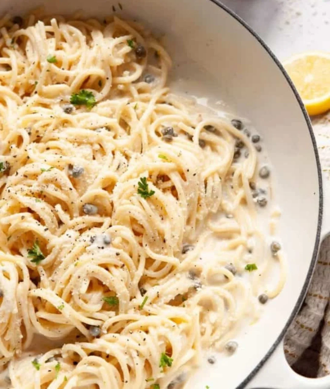 Delicious creamy lemon caper pasta garnished with fresh herbs