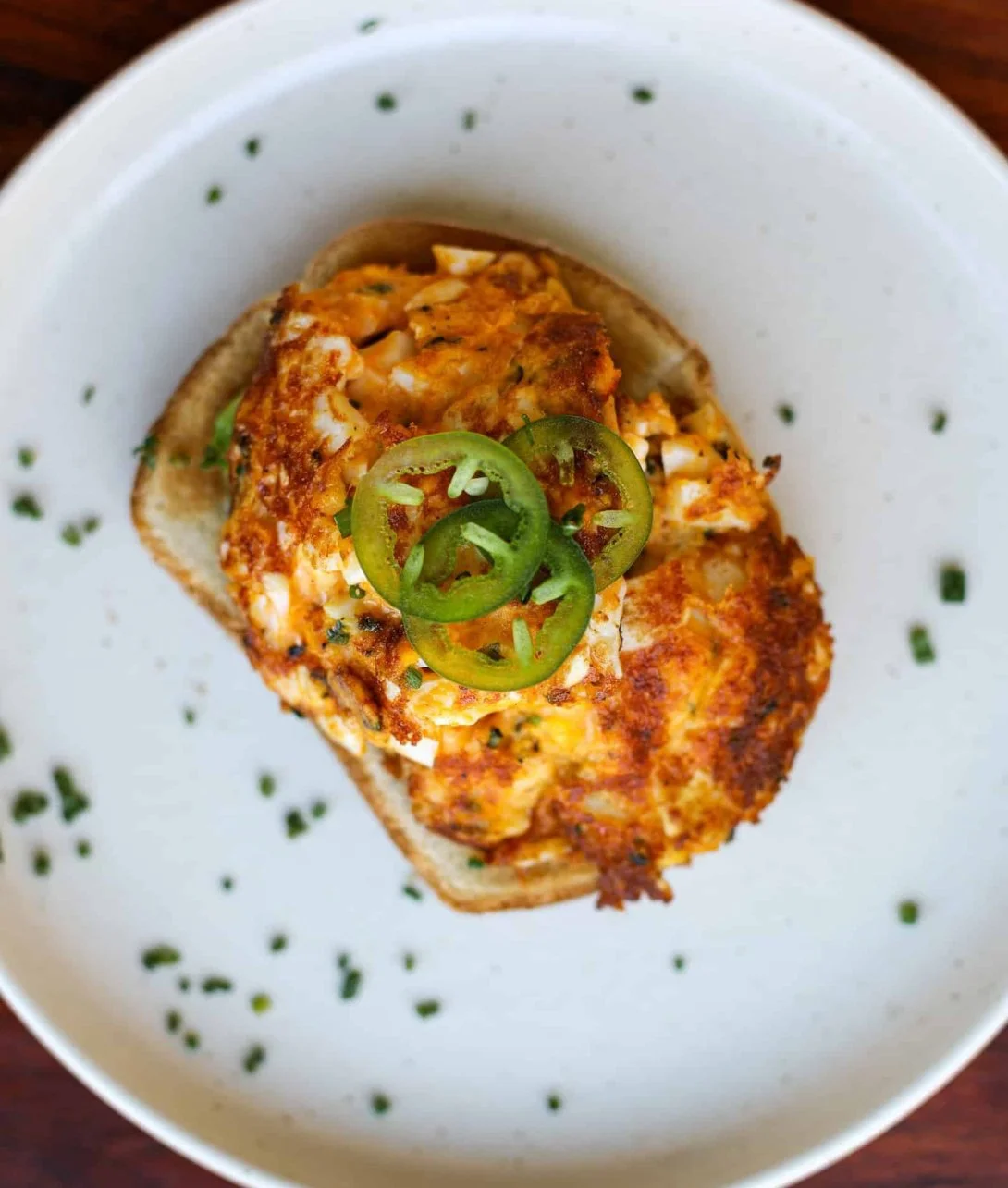 Crispy egg salad served in a bowl with fresh herbs and spices