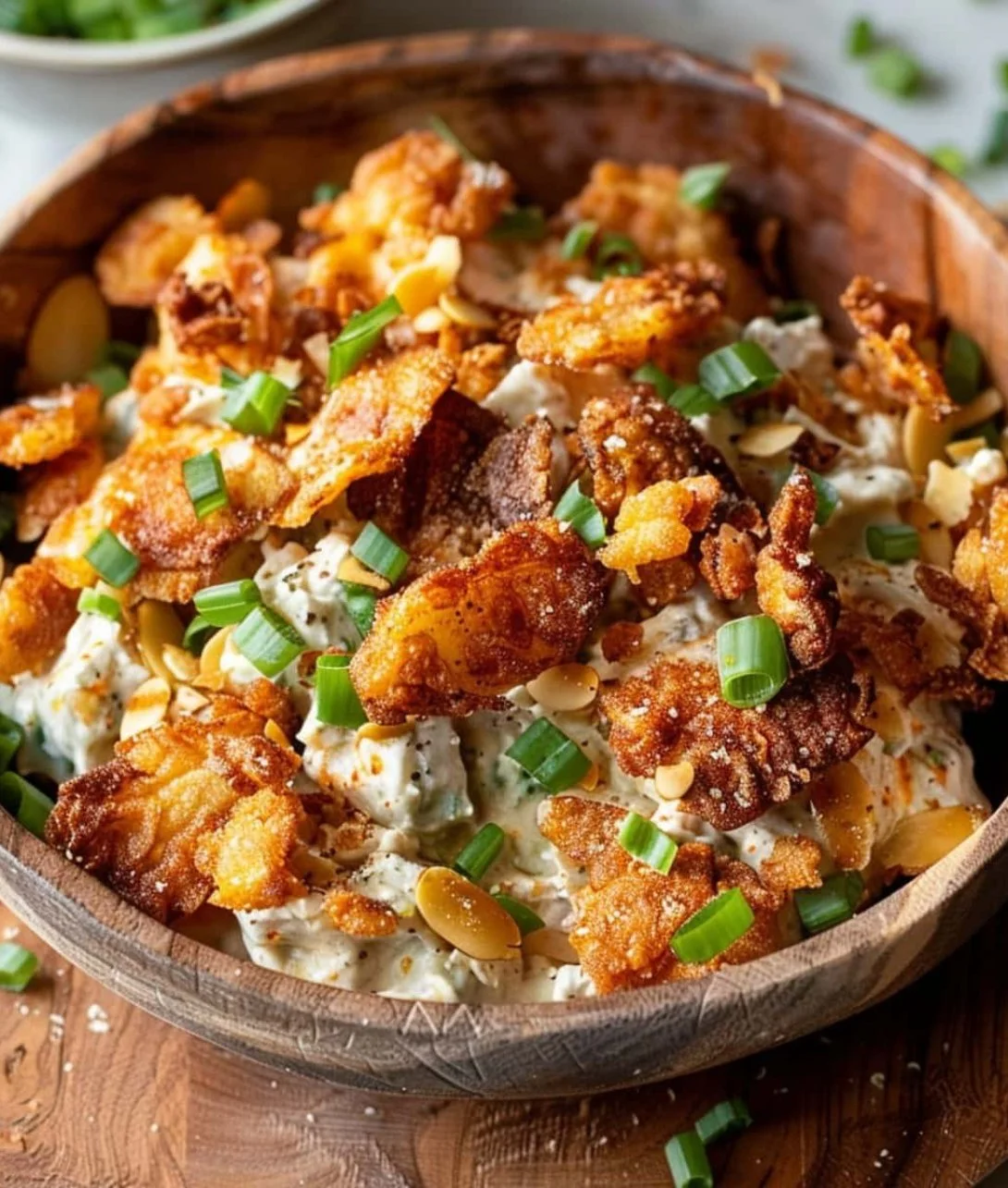Crispy smashed potato salad garnished with fresh herbs and spices