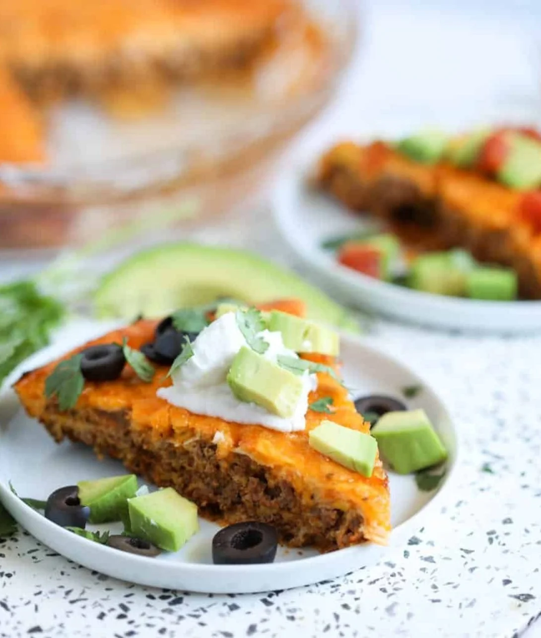 Crustless Keto Taco Pie topped with cheese and fresh toppings