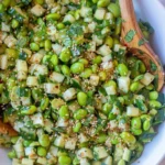 Bowl of fresh Cucumber Edamame Salad with vibrant vegetables and dressing