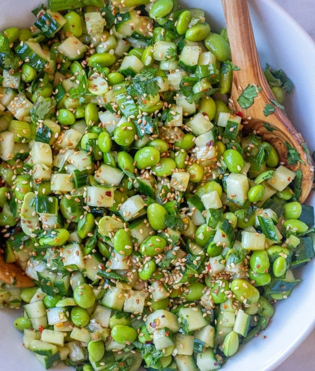 Bowl of fresh Cucumber Edamame Salad with vibrant vegetables and dressing