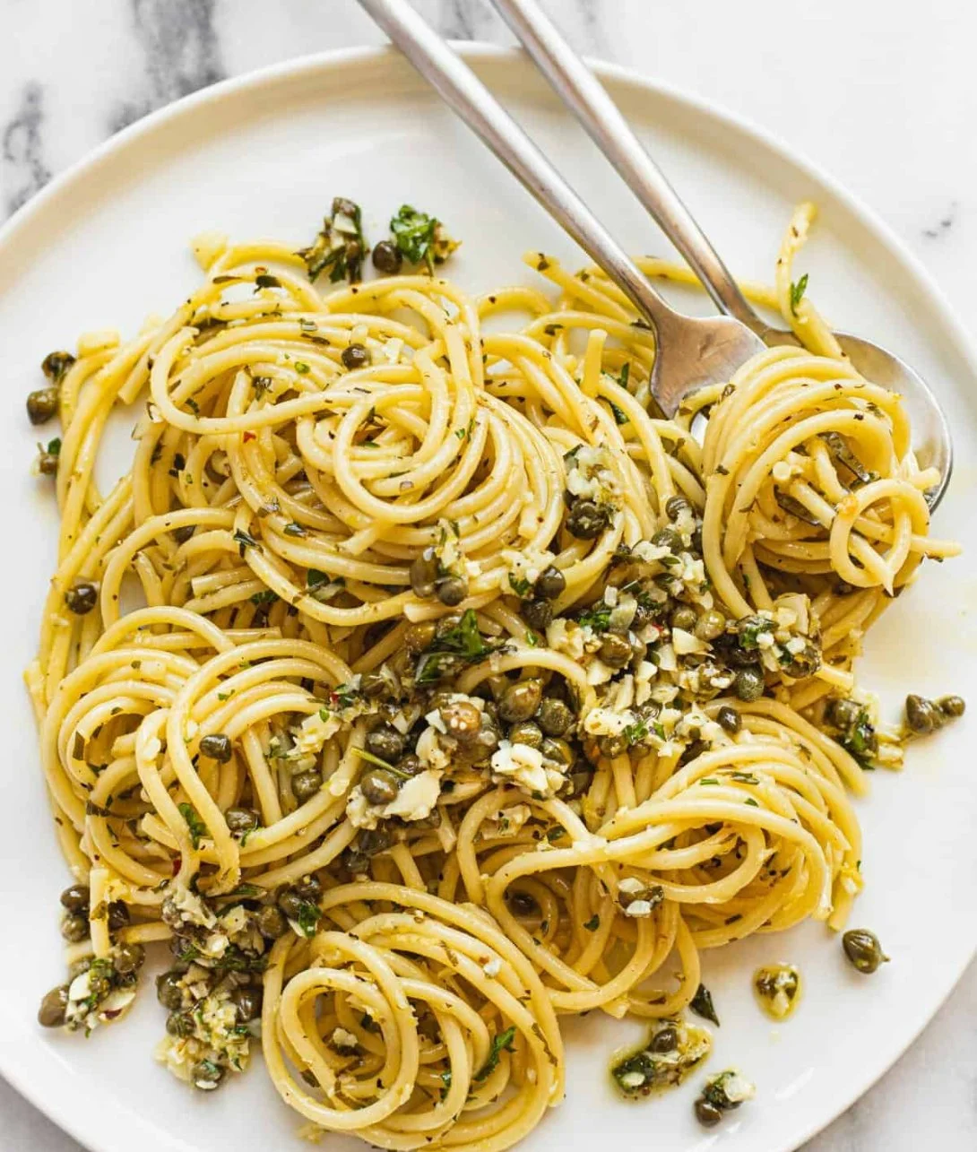A plate of easy 20 minute lemon garlic pasta garnished with fresh parsley.