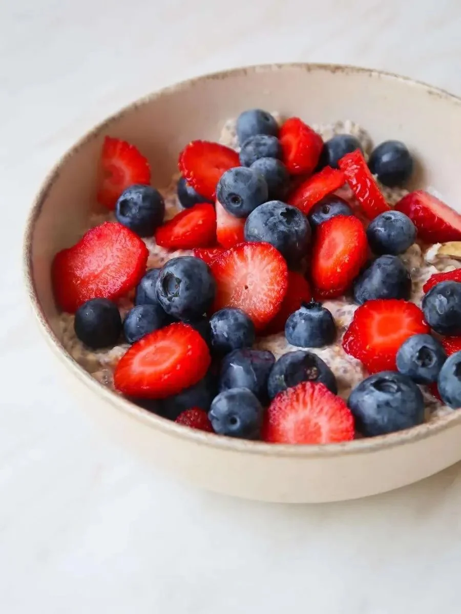 Bowl of easy overnight oats topped with fruits and nuts for a nutritious breakfast