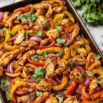 Easy sheet pan chicken fajitas served with fresh veggies and spices.