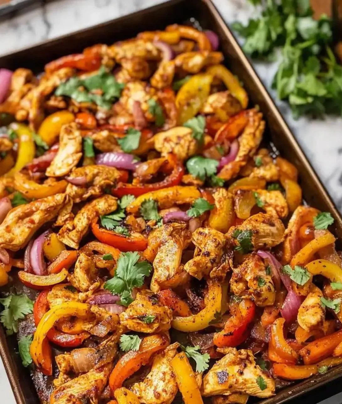 Easy sheet pan chicken fajitas served with fresh veggies and spices.