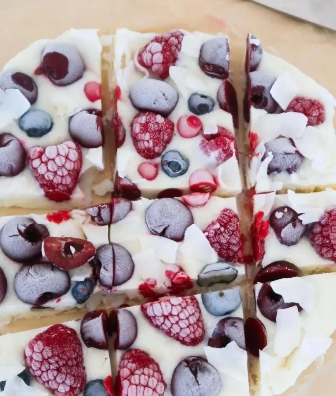 Easy yogurt bark topped with fruits and nuts on a plate