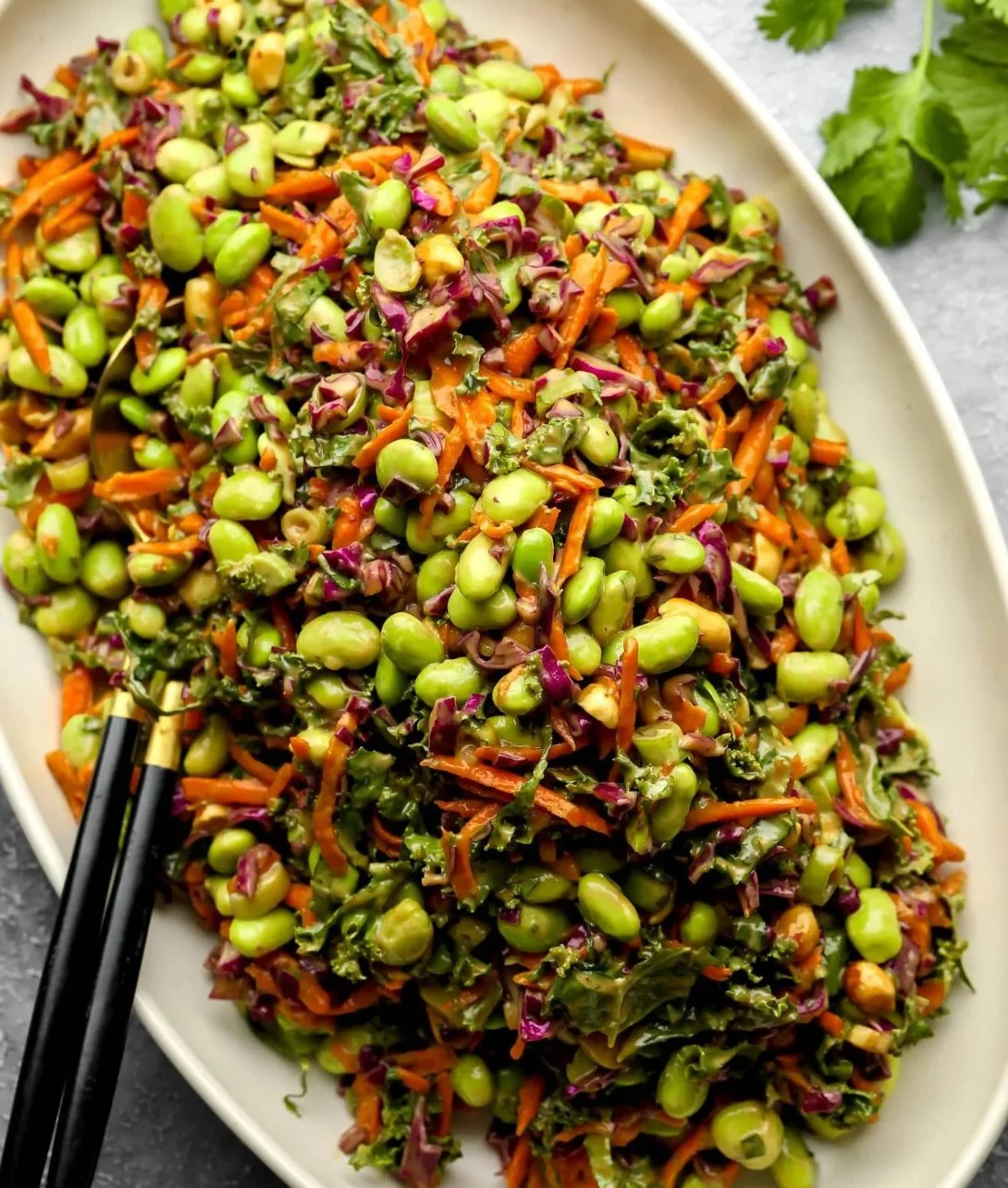 Edamame salad topped with peanut sauce in a vibrant bowl