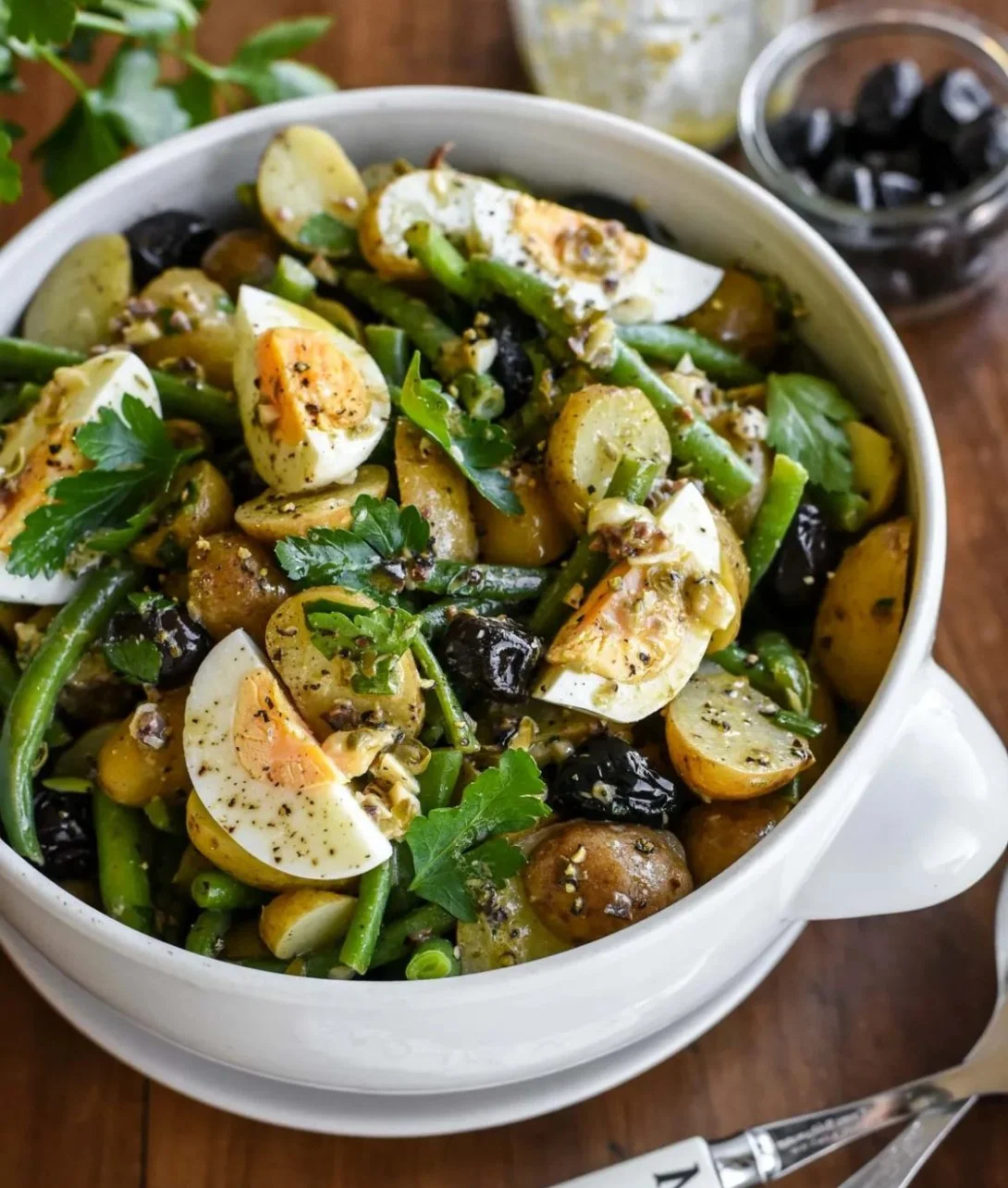 French-style potato salad with green beans on a rustic plate