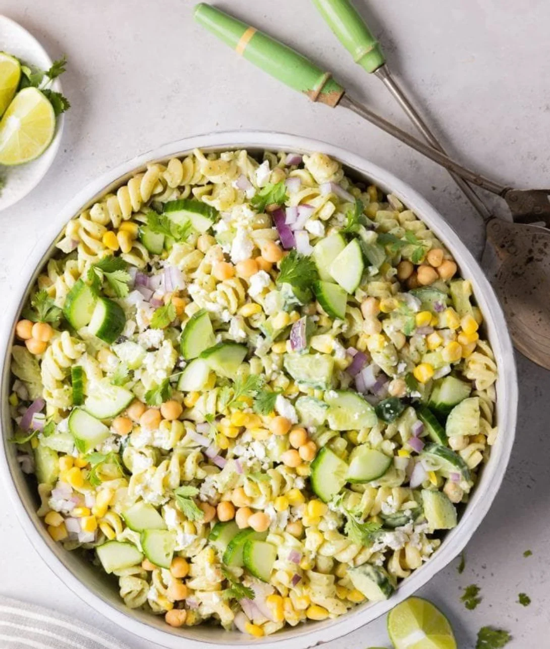 A vibrant bowl of cilantro lime pasta salad with fresh vegetables and lime dressing