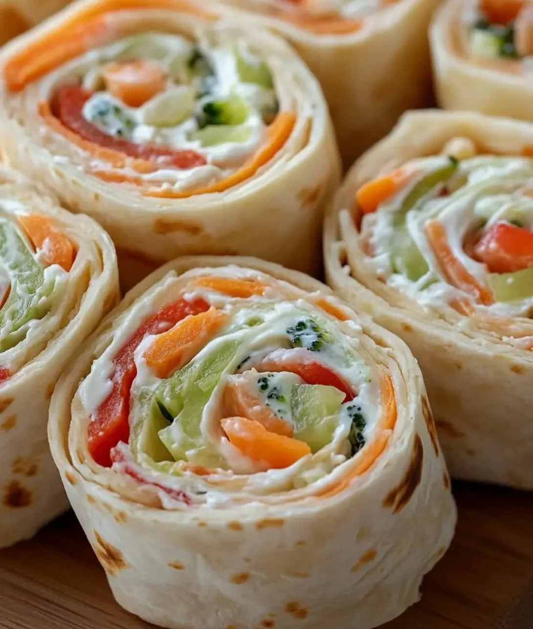 Fresh vegetable tortilla roll ups filled with colorful veggies and herbs