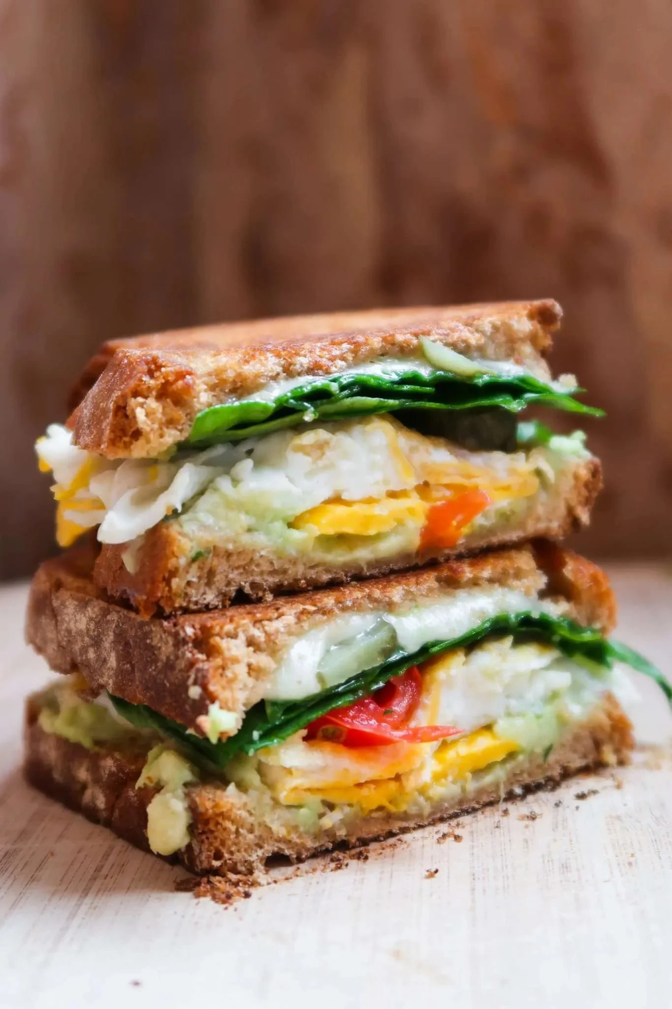 Healthy avocado egg breakfast sandwich on whole grain bread