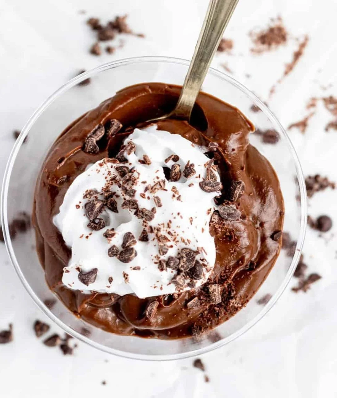 Bowl of healthy chocolate avocado pudding garnished with berries